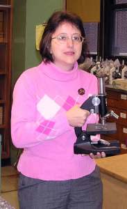 Mrs. J. Gutierrez Holding Microscope